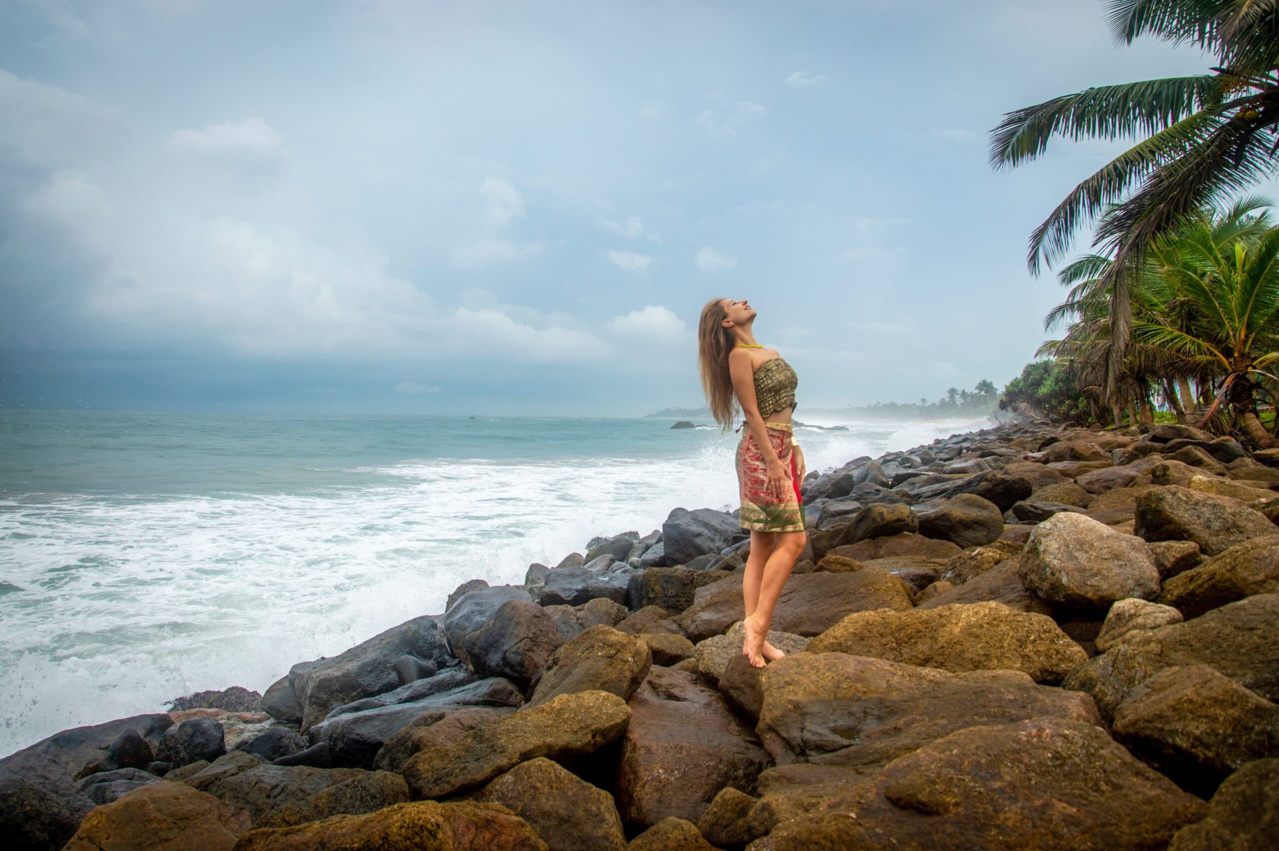 Traveller on the rocks of Sri Lanka's southern coast